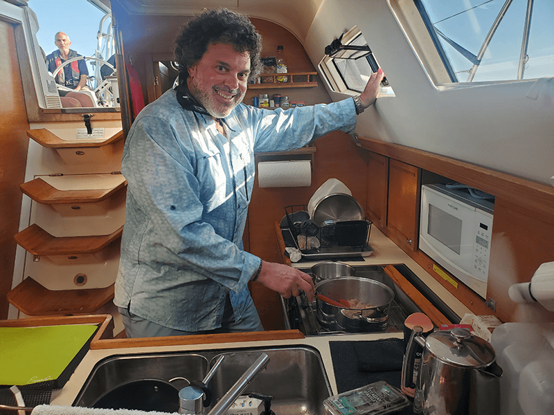 Crew sharing a meal together in the galley during passage training
