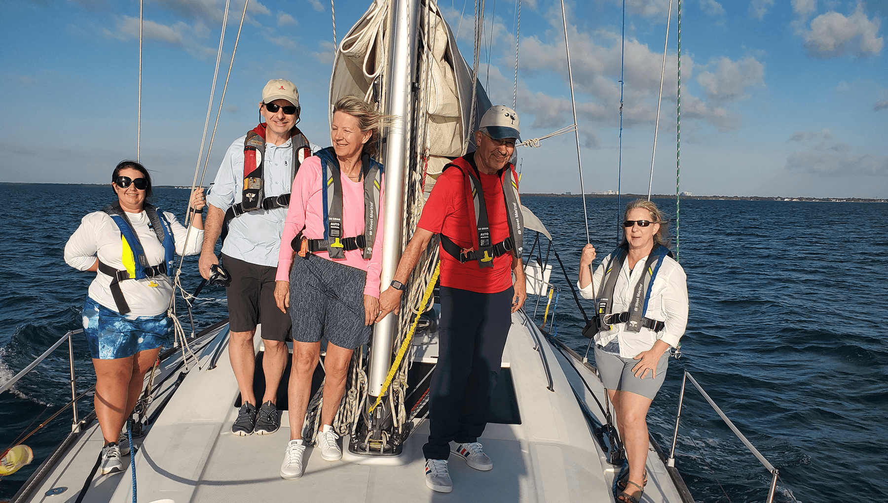 Crew aboard an offshore sailing yacht on passage